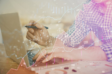 Multi exposure of forex graph with man working on computer on background. Concept of market...
