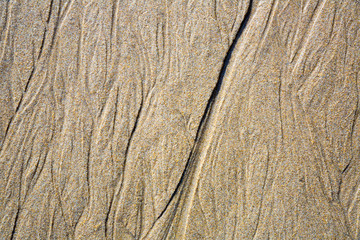 Patterns on the sand from sea water after low tide, Spain