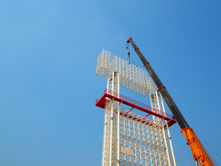 Man Working on the Working at height on construction site with blue sky