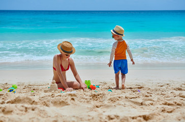 Toddler boy on beach with mother