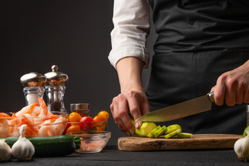 Cooking seafood salad. Chef slices zucchini. Cooking and recipe book. Hotel or restaurant business