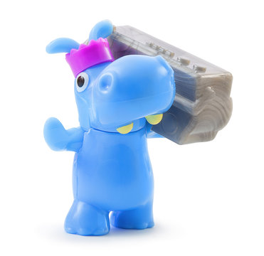 Rhinoceros plastic toy toy. With clipping path. Isolated on white background with natural shadow. With vector path. Toothy rhino plaything with magnetophon on white bg.