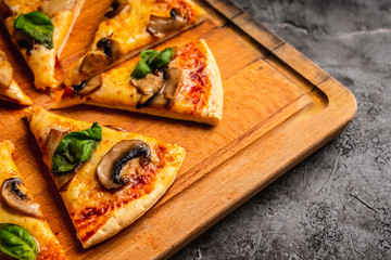 Freshly making pizza with mushrooms served on the rustic background. Selective focus. Shallow depth of field.