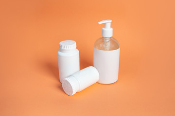 Set of cosmetic containers. white jars on a beige background