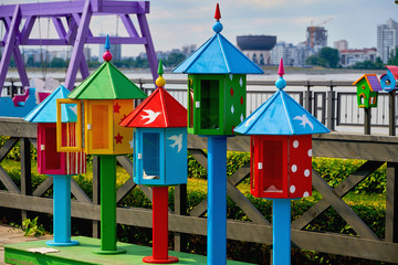 Colorful decorative birdhouses for birds on the street in the Park. Art object birdhouses.