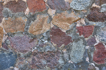 Background masonry made of natural stone. Cement and cobblestones.
