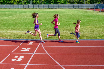 Fototapeta premium Family fitness, mother and kids running on stadium track, training and children sport healthy lifestyle concept 