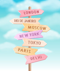 Vector wooden colorful signpost with direction to different cities. Travel sign board arrow illustration on sky background - 338339075