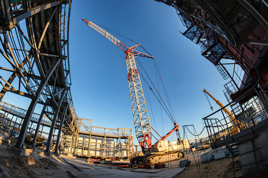 A self-propelled crawler crane stands on a construction site