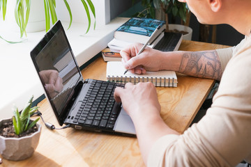 The concept of distance work or online learning during the quarantine virus. Young man working on...