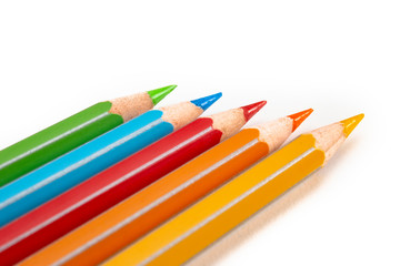 Colored pencils isolated on white. Macro still-file picture made in studio with softbox.