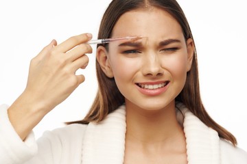 young woman applying mascara