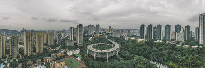 Aerial pano drone shot of particular double circle flyover road in densed residential buildings in...