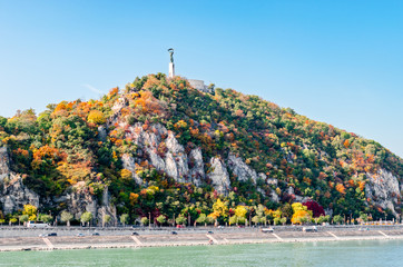 Gell&eacute;rt Hill in Budapest in autumn colors with the Liberty Statue on the top.