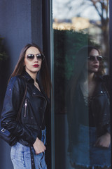 Young beautiful girl in stylish sunglasses in street