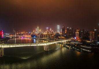 Fototapeta na wymiar Aerial night view of Hong Ya Dong cave with Huanghuayuan and Qiansimen Bridge in Chongqing, southwest China