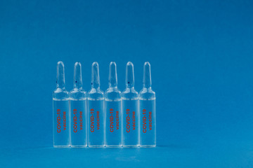 Medicine in an ampoule on a blue background.