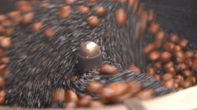 Food Video Scene of roast chestnut with sand grain. Put the dried sand into the big tray The hot sand is heated This is good for making chestnuts ripen close up shot in 4K resolution.
