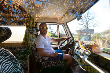 Portrait of careless man during holidays camping in his van