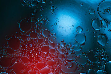 abstract blue liquid with bubbles in colorful light
