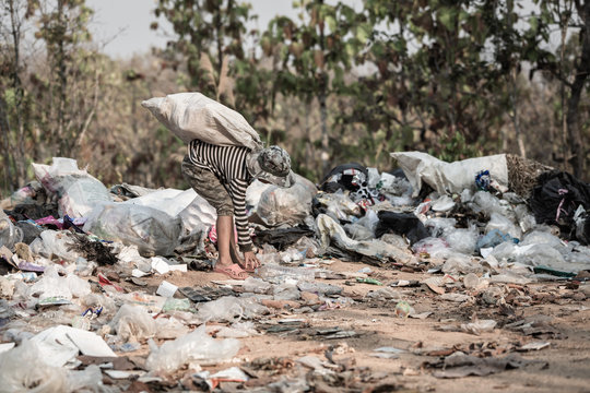 Poverty in India, a child collects garbage in a landfill site, Concept of livelihood of poor children.Child labor. Child labor,  human trafficking, Poverty concept.