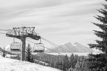 Ski Chairlift going down a mountain in the French Alps