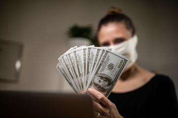 Woman counting money bills during corona time.