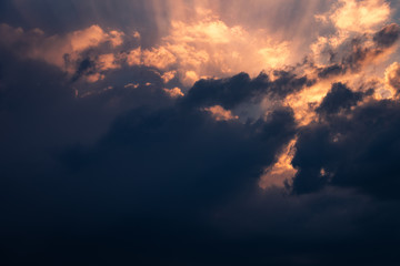 Dramatic Sunset in the clouds with lightbeams shining through