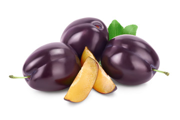 fresh purple plum and slices with leaves isolated on white background with clipping path and full depth of field