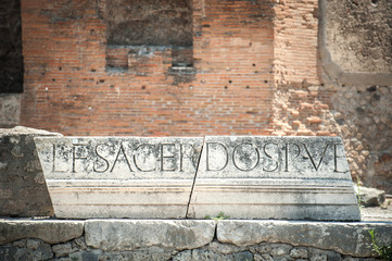 Latin inscription that once formed part of the marble portico that ran around the top of the colonnade of the Forum in Pompeii, Italy