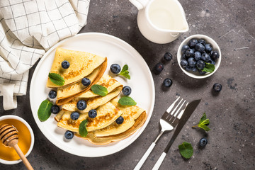 Crepes with blueberries and honey.