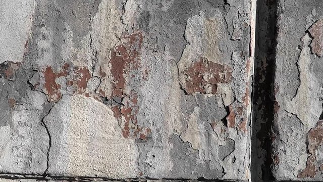 texture of the background of the old wall of the building made in the form of blocks, the paint from which has long fallen away
