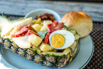 Traditional Tropical Thai salad, its serving  on pineapple with egg and some vegetables