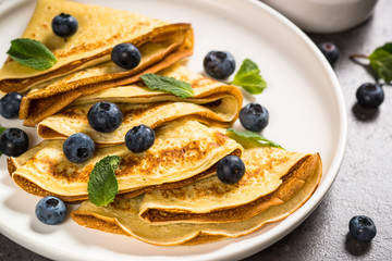 Crepes with blueberries and honey.