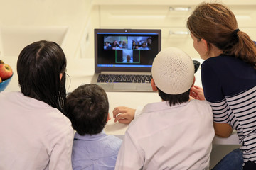 Happy family having a video chat with their family.