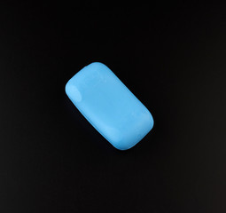 blue soap on a black background, top view