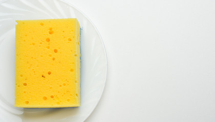 Dishwashing concept. Plate with sponge on white background