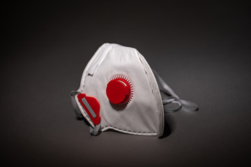 safety mask - breathing mask - respirator on dark background - covid-19 - corona