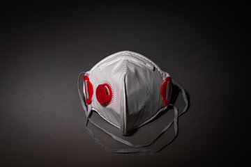 safety mask - breathing mask - respirator on dark background - covid-19 - corona