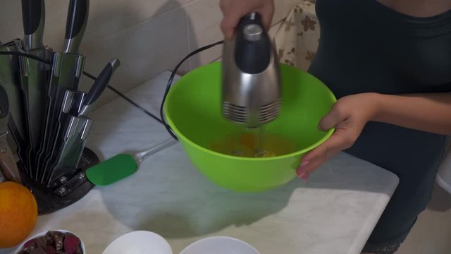 Whisking Egg With Handheld Electric Egg Beater - Closeup shot