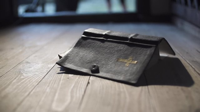 Shot of the Bible falls to the ground on slow motion