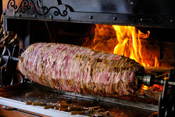 Cag Kebap, Traditional Turkish Kebap being prepared by chef. Slicing kebab to serve.