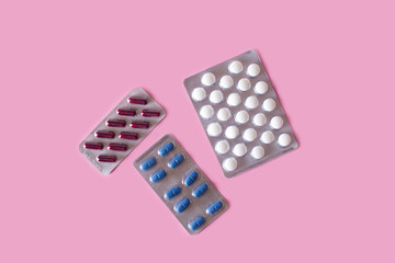 Medical pills on pink background. Top view