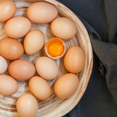 Organic raw brown chicken eggs in a ceramic old dish. Easter. Rustic style. Selective focus, top view, square image