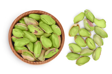 peeled pistachio in wooden bowl isolated on white background with clipping path and full depth of field. Top view. Flat lay
