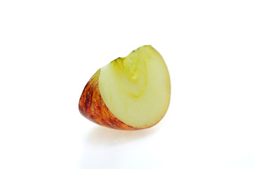 Red apples that are cut into pieces placed on a white background, taken with a macro lens