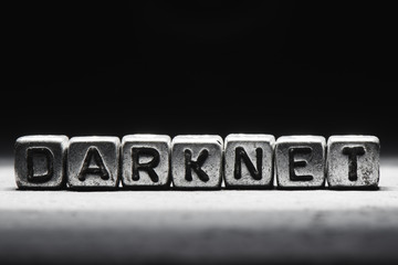 Darknet concept, inscription on metal cubes isolated on dark background