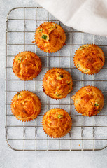 Delicious freshly baked homemade Savory muffins with Parmesan cheese, sausage or ham and green peas for Breakfast. Selective focus, top view