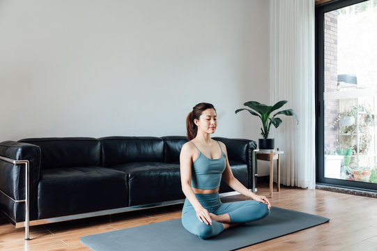 young asian beauty woman doing yoga at home