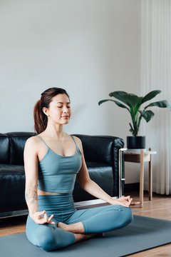 young asian beauty woman doing yoga at home